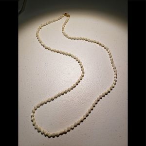 Vintage 30 inch long strand of mother of pearl beads with gold barrel clasp